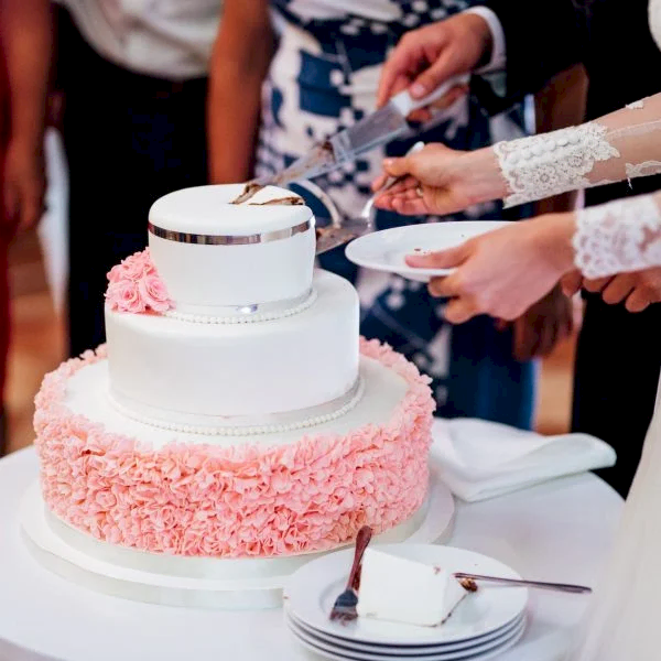 newlyweds-happily-cut-and-taste-the-wedding-cake.jpg